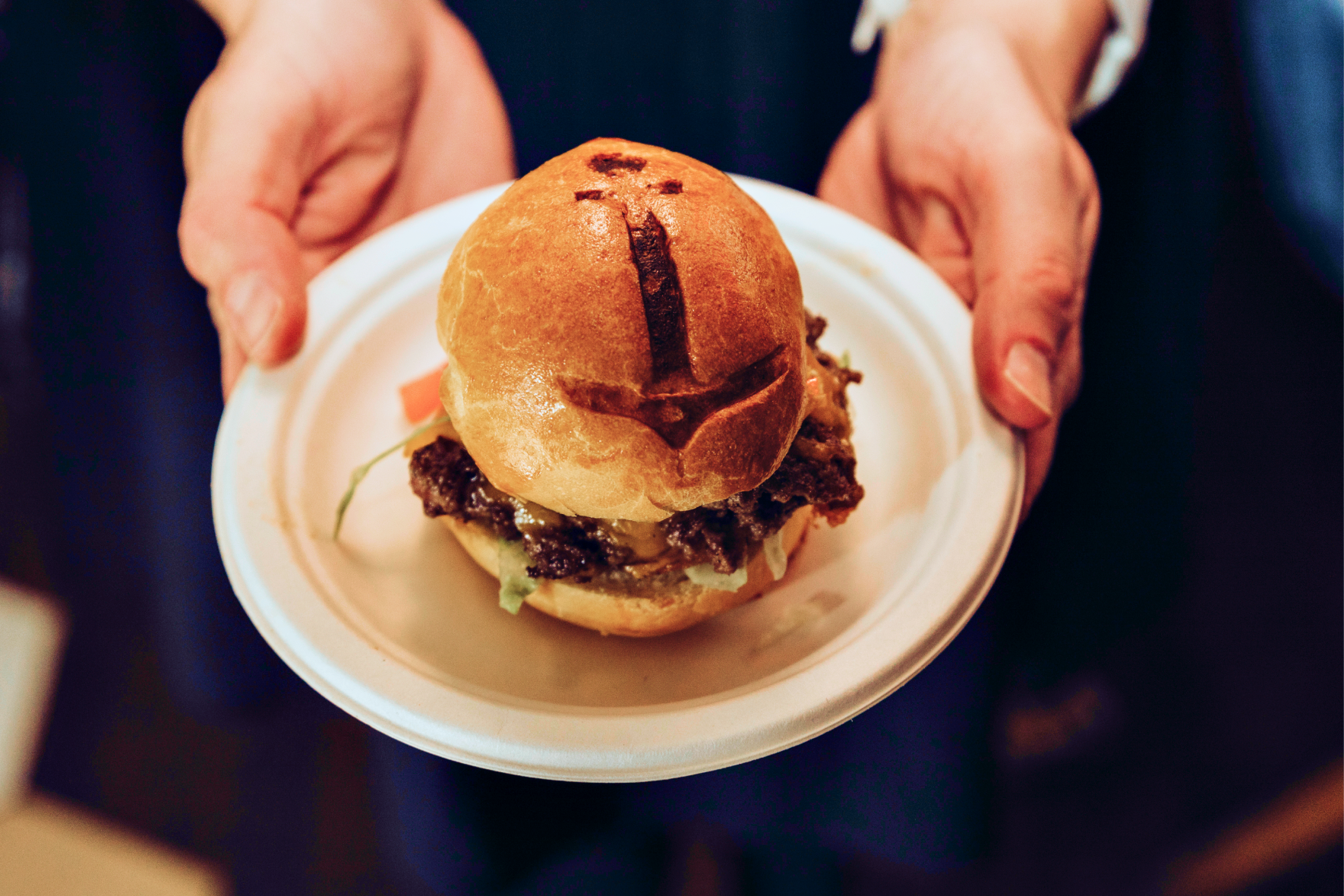A cheeseburger on a brioche bun served on a plate at The Portside Pub & Grill